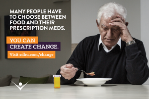 Many people have to choose between food and their prescription meds. Image of a senior man hesitantly eating soup beside an empty pill bottle. You can create change.